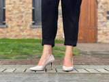 Comfortable, quality European women's stiletto sandal in patent leather. Wedding or special occasion shoe in nude.