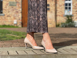 Comfortable, quality European women's stiletto sandal in patent leather. Wedding or special occasion shoe in nude.