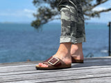 Quality European women's sandals. Made in Spain contoured cork footbed and rubber sole. Comfortable slide style sandal with cosmetic buckle detail. Birkenstock style sandal in brown.