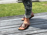 Quality European women's sandals. Made in Spain contoured cork footbed and rubber sole. Comfortable slide style sandal with cosmetic buckle detail. Birkenstock style sandal in brown.