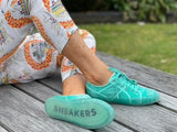 European sustainable women's fashion sneakers. Sole made from recycled plastic. Made in Spain in green colour.