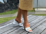 Classy European women's sandals with gold bit detail. Mule style on chunky block heel. Wedding or special occasion slide. In white.