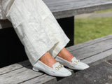 A pair of white loafers with gold embellishment detailing, comfortable, quality European women's shoes. Soft square toe available in white.