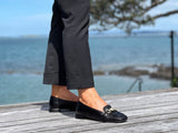 A pair of white loafers with gold embellishment detailing, comfortable, quality European women's shoes. Soft square toe available in black.