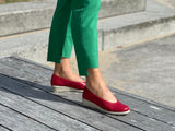 A person wearing a pair of red Aerobics Lockheed 1 ballet shoes with a contoured insole and a lightweight rubber sole . Quality European women's footwear made from soft leathers.