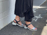 Woman's black and silver chunky sole sandal with a buckle fastening. Buckle up ankle strap, lightweight and cushioned footbed.
