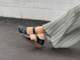 Smart black sandal in soft leather uppers. Velcro strap, wedge sole unit with enclosed heel and enclosed toe. Comfortable women's sandal with floral detail. Women's shoes with cushioned footbed.