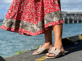 Quality European women's slide sandal. Soft leather with frill trim. In taupe