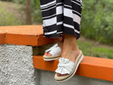 Aerobics are quality European women's sandals and slides. Soft leather with bow detail in white.