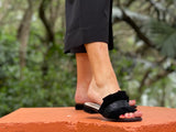 Quality European women's slide sandal. Soft leather with frill trim. In black