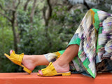 Quality European women's slide sandal. Soft leather with frill trim. In yellow