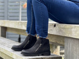 A pair of black ankle boots with a quality leather upper and a stacked sole unit. European, made in Portugal. Comfortable women's shoes with two zippers.