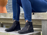 A pair of black ankle boots with a quality leather upper and a stacked sole unit. European, made in Portugal. Comfortable women's shoes with two zippers.