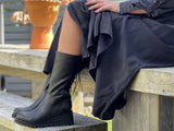 A pair of black mid calf ankle boots with a full inside zip and stitched decorative lace detail on the back of the calf. Wedge platform sole unit. Women's shoes, European made in Portugal from quality leather. Comfortable boots.