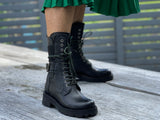 Women's boots, refined, combat style, quality leather boot, lace up with elasticated gusset and buckle detail. European, hand made in Portugal. Stylish and comfortable ankle boot. Midcalf black boot with a chunky rubber sole.