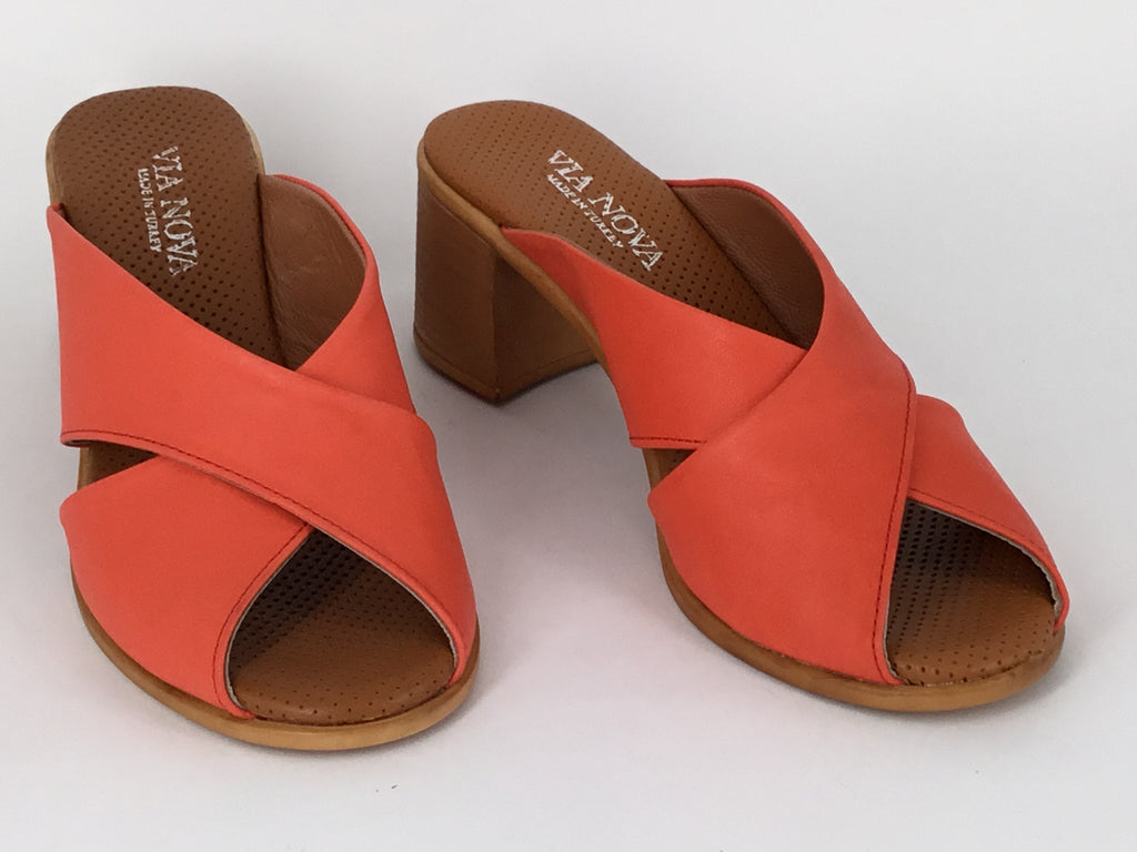 A person wearing Via Nova Hanky sandals in red color, with enough space to insert a foot not shown, v throat with crossover straps and block heel. Comfortable footbed.