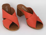 A person wearing Via Nova Hanky sandals in red color, with enough space to insert a foot not shown, v throat with crossover straps and block heel. Comfortable footbed.