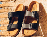 Quality European women's sandals. Made in Spain contoured cork footbed and rubber sole. Comfortable slide style sandal with double buckle detail. Birkenstock style sandal in black.