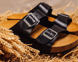 Quality European women's sandals. Made in Spain contoured cork footbed and rubber sole. Comfortable slide style sandal with double buckle detail. Birkenstock style sandal in black.